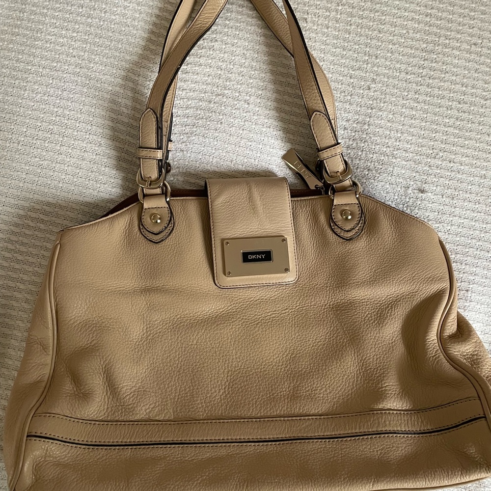 DKNY tan leather purse with brown satin lining.